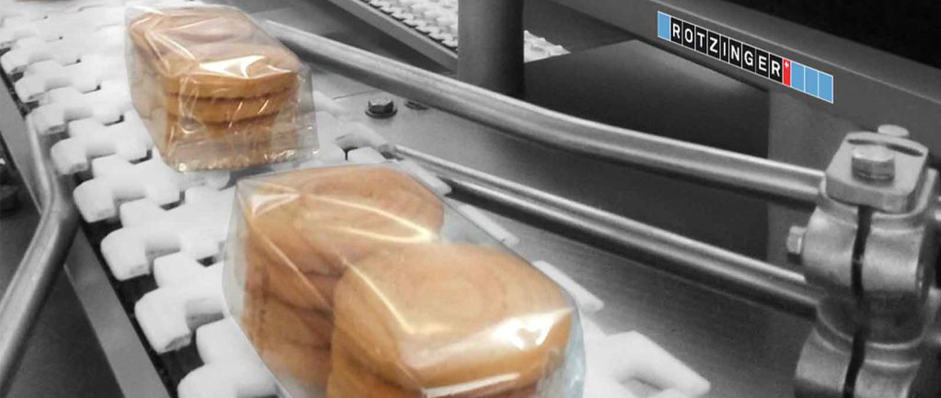 Packed bakery products on Rotzinger equipment for product flow regulation.