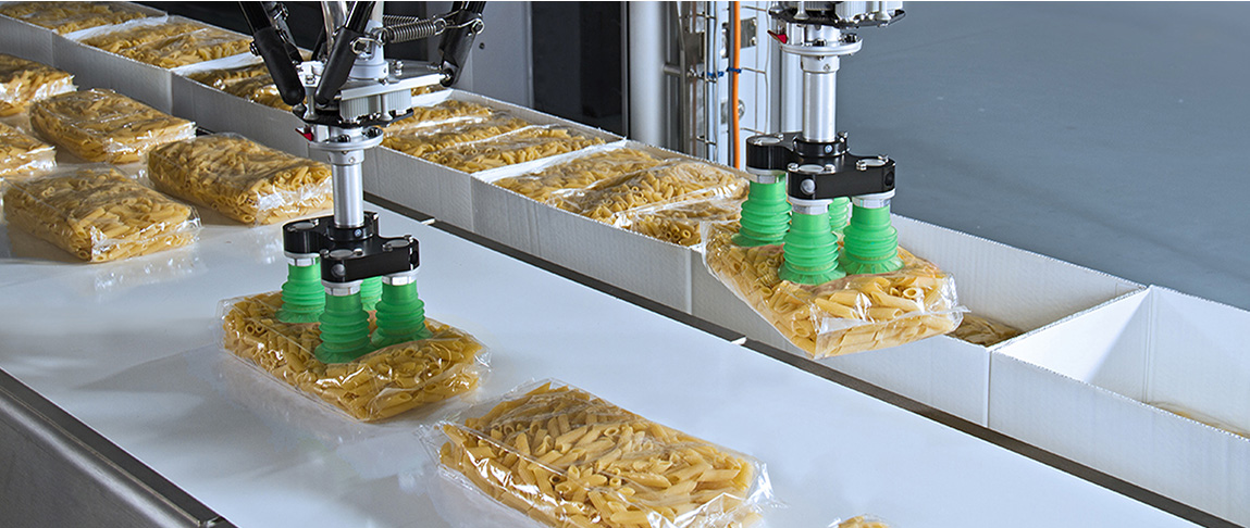 Delta robots pick pasta in plastic bags and place them in a cardboard box.