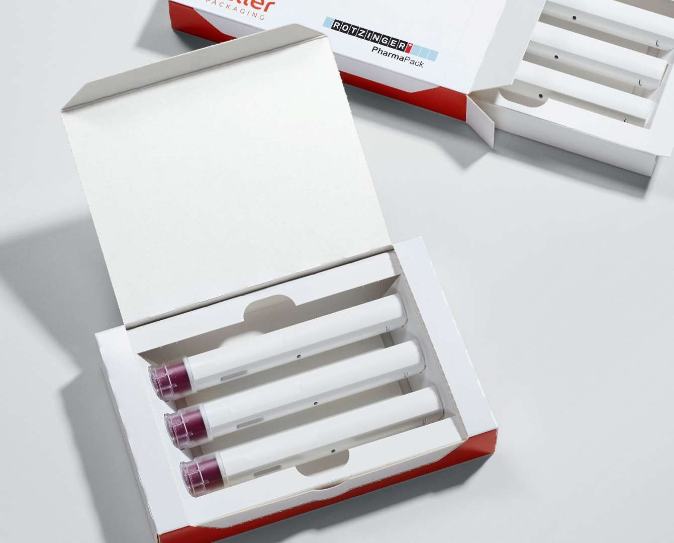 Set of Auto-injectors inside eco-save package Rotzinger PharmaPack